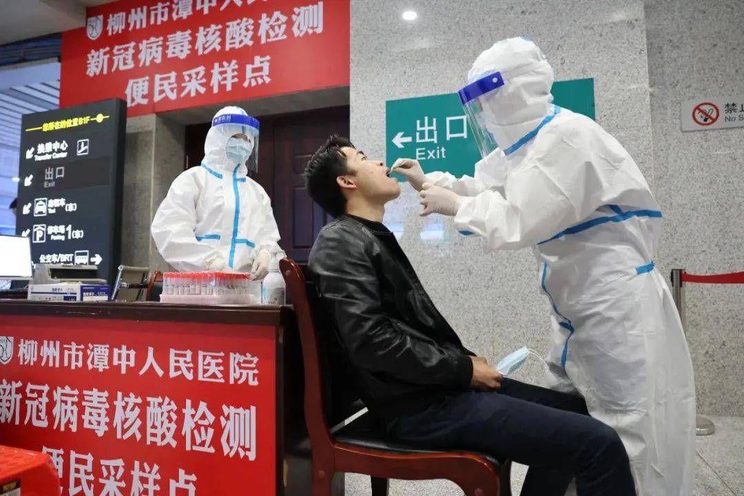 医务人员正在为旅客进行口咽拭子核酸检测.