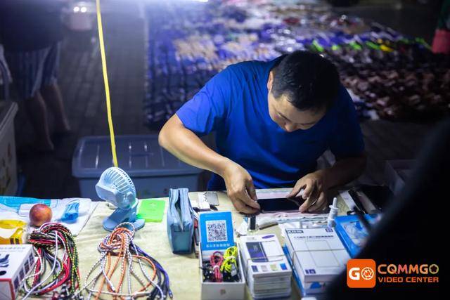 靠近廖先生贴膜摊的是个服装摊 摆着各式各样的休闲裤和衣服 摊主是一