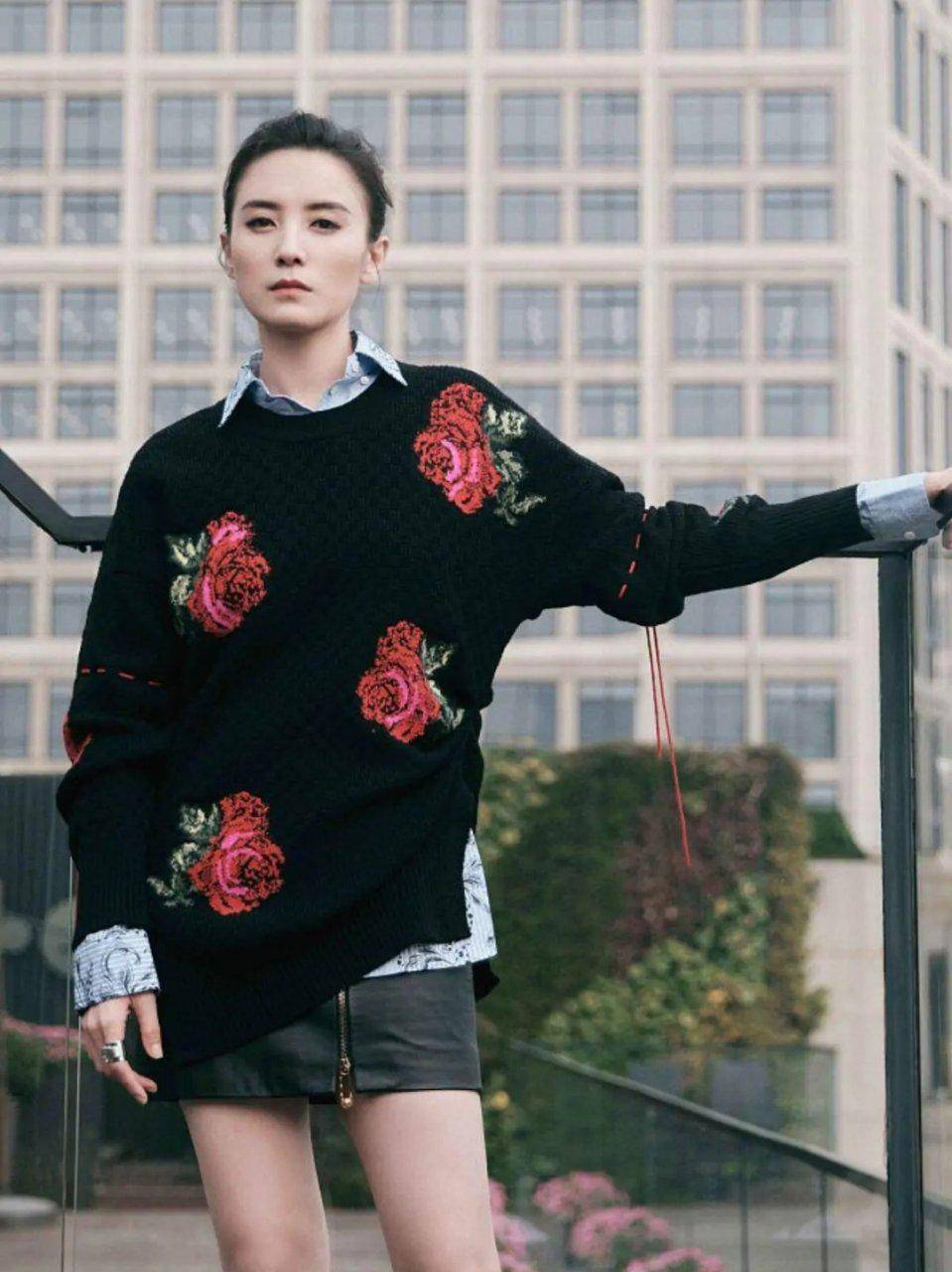 好身材 身穿一件印花设计的黑色针织衫叠穿浅色条纹衬衫,很有层次感,再搭配皮质短裙