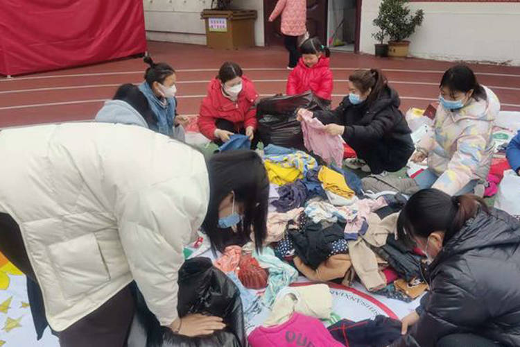 老师们将捐赠好的衣物整理,打包,消毒……一件件不起眼的旧衣物,也许