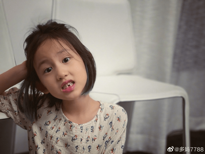 多妹披着短发,穿着薄薄的裙衫,张嘴故意露出掉牙的地方.