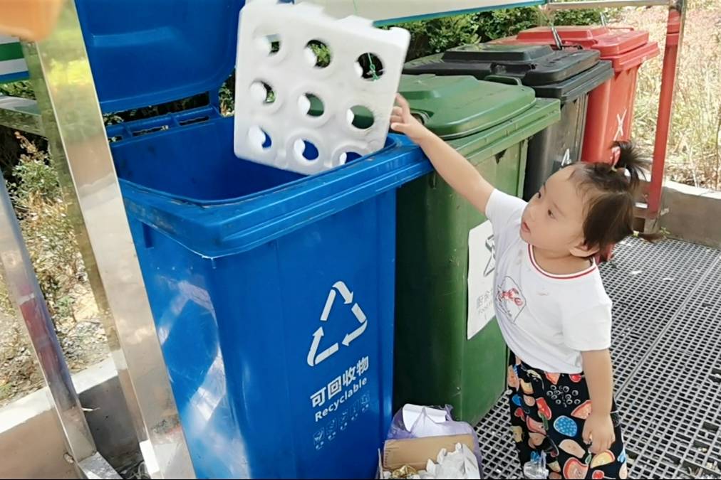 大伯带小萌宝扔垃圾把装苹果的泡沫盒扔垃圾桶