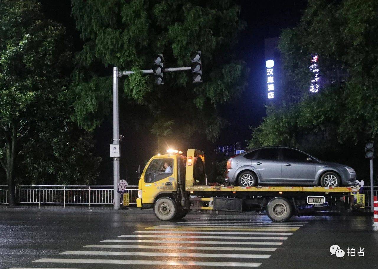 7月8日,歙州大道上,因涉水受損的車輛正運上拖車.