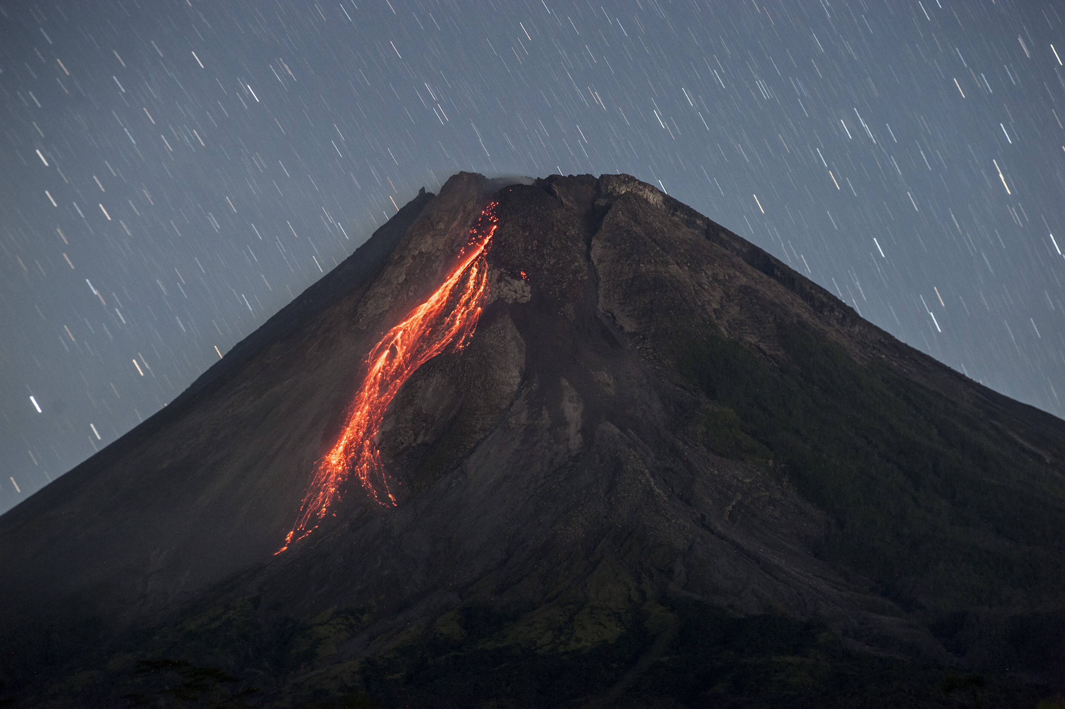 是4月21日在印度尼西亚日惹拍摄的喷发的默拉皮火山(长时间曝光照片)
