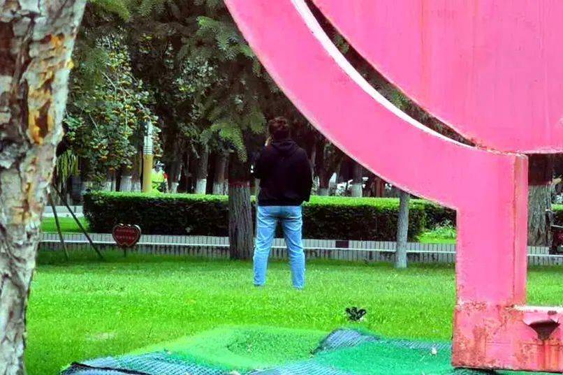 石河子市音乐广场一行人随意践踏草坪.