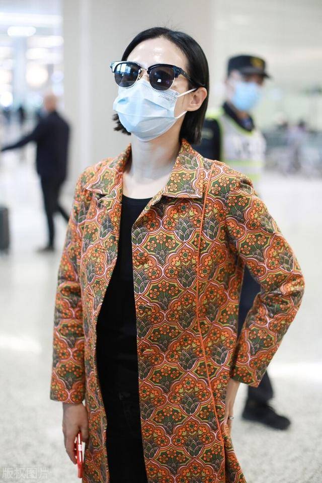 谭卓一袭橘色印花大衣现身机场,素颜出行戴墨镜白皙皮肤尽显_气质