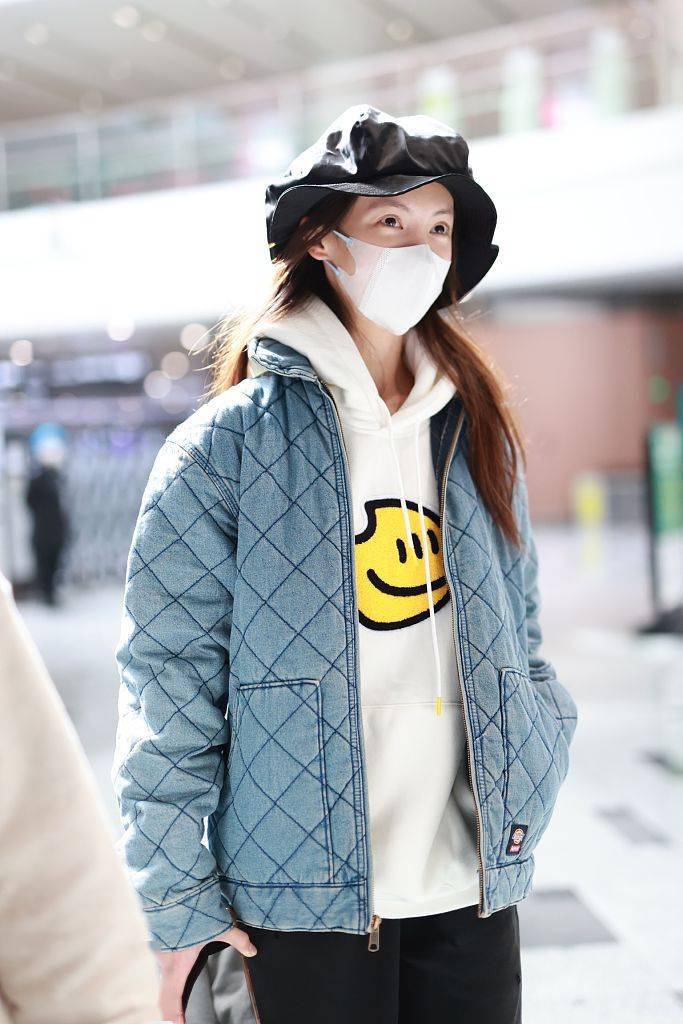 金晨戴黑色潮帽现身机场蓝外套内搭笑脸卫衣清爽时尚