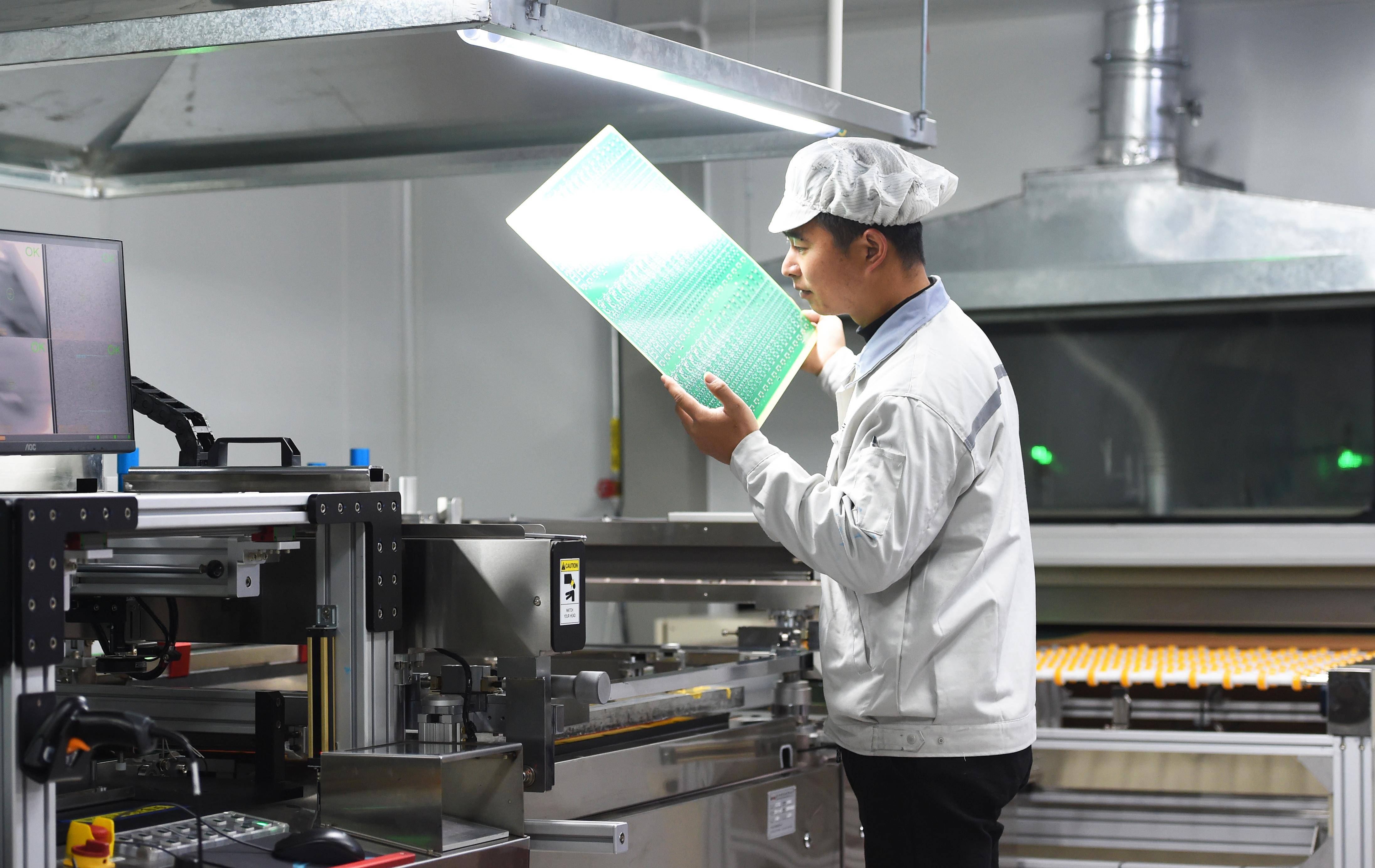 1月30日,在浙江省杭州市临安区一家电子企业,员工在检查流水线上的